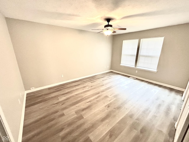 10922 Snowdrop Way, Indianapolis, IN 46235 - empty room featuring a ceiling fan, baseboards, and wood finished floors