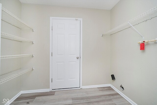2834 Wolfgang Dr, Indianapolis, IN 46239 - laundry area featuring light wood-type flooring and baseboards