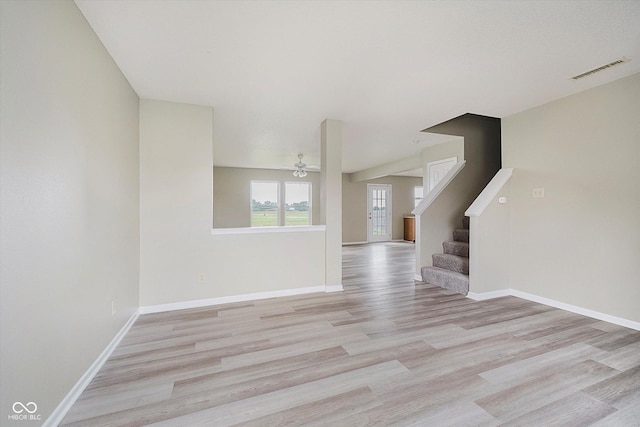2834 Wolfgang Dr, Indianapolis, IN 46239 - unfurnished living room featuring light wood finished floors, ceiling fan, baseboards, and stairway