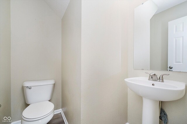 2834 Wolfgang Dr, Indianapolis, IN 46239 - bathroom with toilet, baseboards, and a sink
