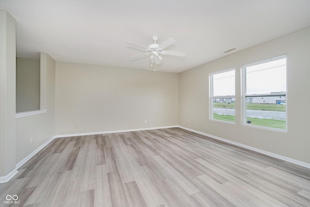 2834 Wolfgang Dr, Indianapolis, IN 46239 - empty room featuring light wood-style floors, a ceiling fan, and baseboards