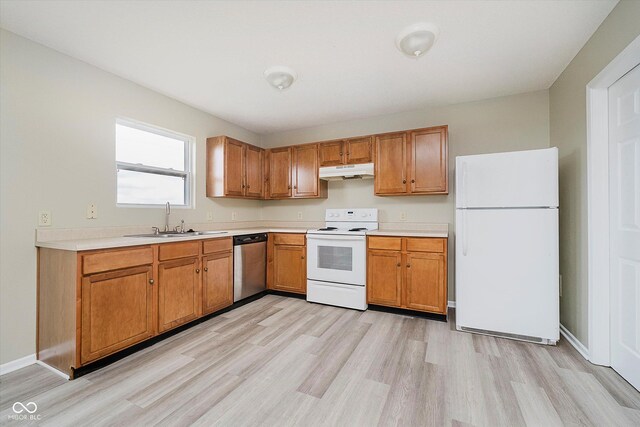 2834 Wolfgang Dr, Indianapolis, IN 46239 - kitchen with white appliances, under cabinet range hood, a sink, light wood finished floors, and light countertops