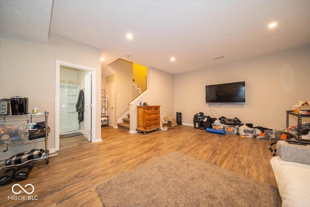 12976 Walbeck Dr, Fishers, IN 46037 - living area with wood finished floors, stairway, and recessed lighting