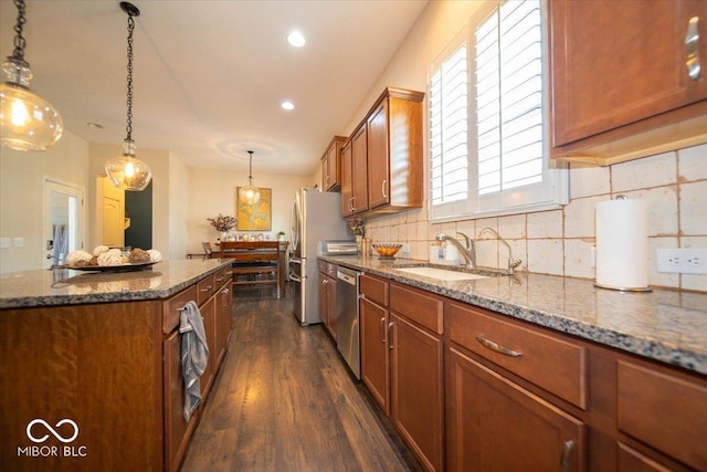 12976 Walbeck Dr, Fishers, IN 46037 - kitchen featuring appliances with stainless steel finishes, brown cabinetry, dark wood finished floors, backsplash, and recessed lighting