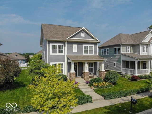 12976 Walbeck Dr, Fishers, IN 46037 - view of front of home featuring covered porch, roof with shingles, and a front lawn