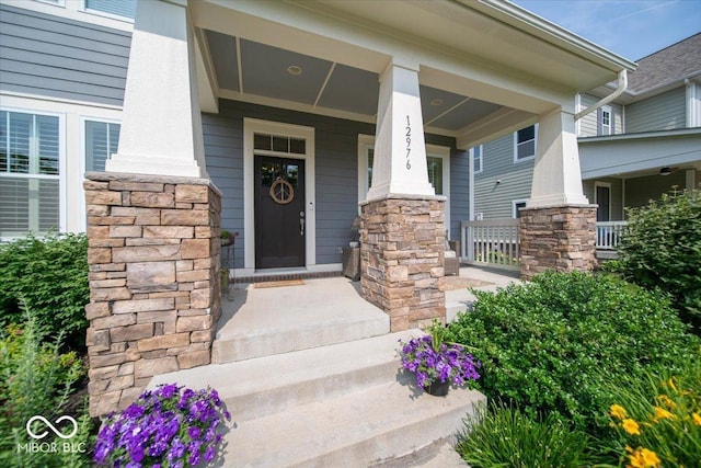12976 Walbeck Dr, Fishers, IN 46037 - doorway to property with a porch and stone siding