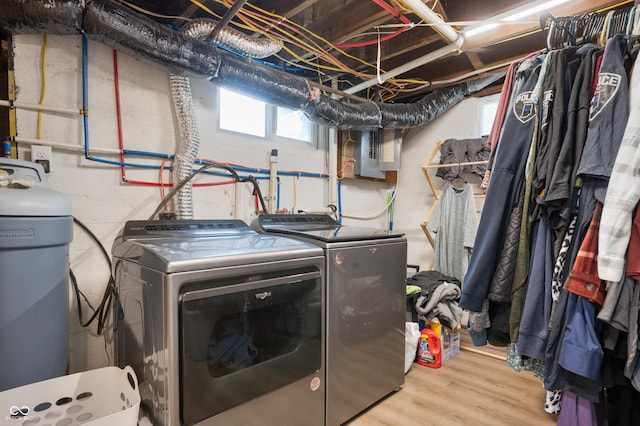 110 E Harrison St, Spiceland, IN 47346 - laundry area with electric panel, washing machine and clothes dryer, wood finished floors, and plenty of natural light
