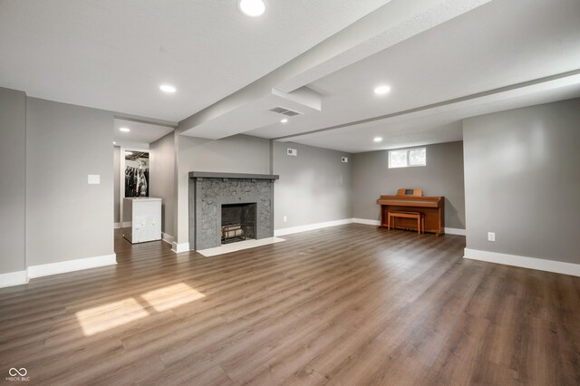 110 E Harrison St, Spiceland, IN 47346 - unfurnished living room featuring recessed lighting, wood finished floors, and a stone fireplace