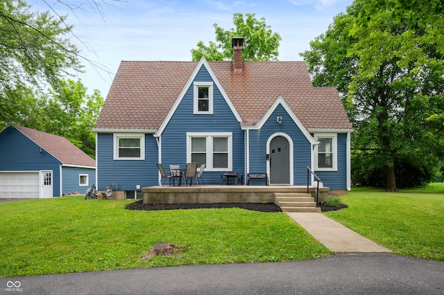 110 E Harrison St, Spiceland, IN 47346 - english style home with a chimney, a front yard, a garage, and a porch