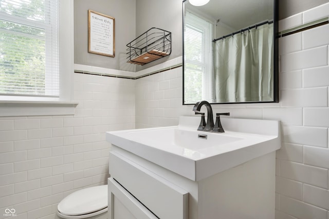 110 E Harrison St, Spiceland, IN 47346 - full bath with tile walls, vanity, plenty of natural light, and a shower with shower curtain