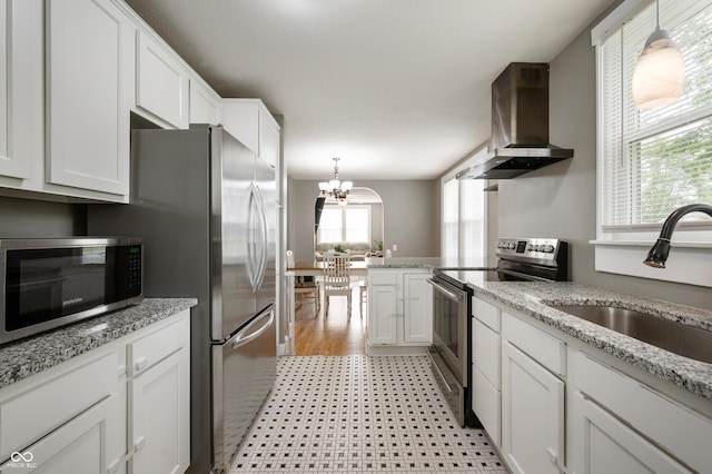 110 E Harrison St, Spiceland, IN 47346 - kitchen featuring appliances with stainless steel finishes, ventilation hood, white cabinets, and a chandelier
