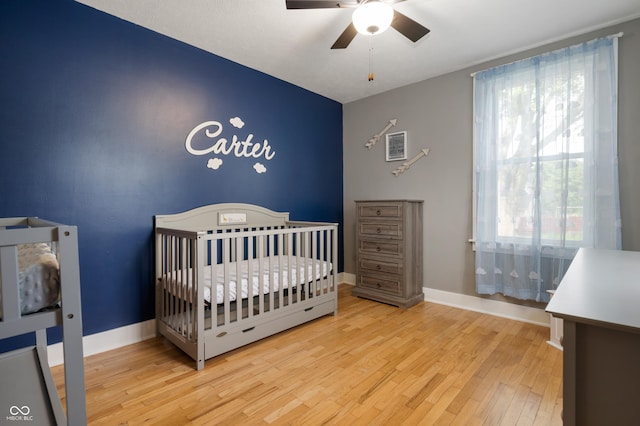 110 E Harrison St, Spiceland, IN 47346 - bedroom with wood finished floors, a nursery area, and ceiling fan