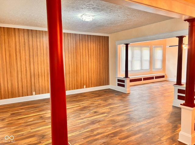 624 N Rural St, Indianapolis, IN 46201 - empty room with a textured ceiling, ornate columns, wood finished floors, baseboards, and crown molding