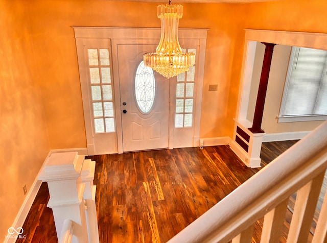 624 N Rural St, Indianapolis, IN 46201 - foyer entrance with a chandelier, dark wood-type flooring, baseboards, and plenty of natural light