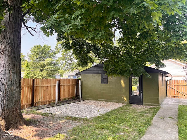 624 N Rural St, Indianapolis, IN 46201 - view of side of home with concrete block siding and a gate