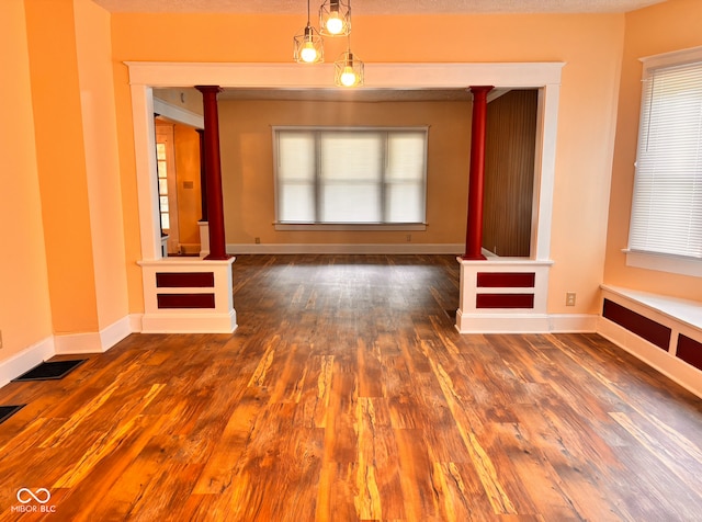 624 N Rural St, Indianapolis, IN 46201 - unfurnished living room with wood finished floors, plenty of natural light, and baseboards