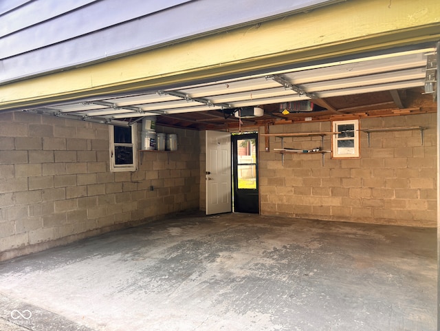 624 N Rural St, Indianapolis, IN 46201 - garage featuring a garage door opener and concrete block wall