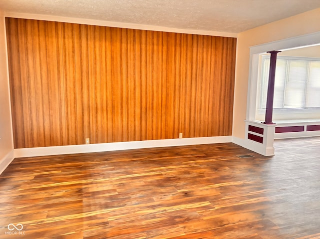 624 N Rural St, Indianapolis, IN 46201 - unfurnished room with wood finished floors, a textured ceiling, and baseboards