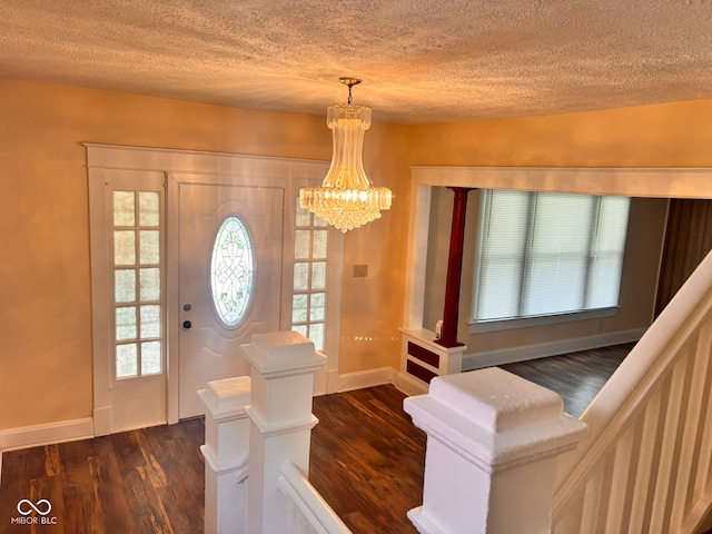 624 N Rural St, Indianapolis, IN 46201 - entrance foyer featuring a textured ceiling, dark wood-style flooring, baseboards, and a chandelier