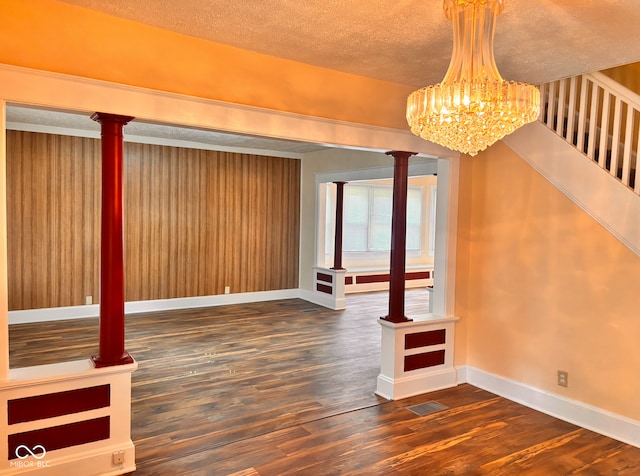 624 N Rural St, Indianapolis, IN 46201 - interior space with wood finished floors, a chandelier, baseboards, a textured ceiling, and ornate columns
