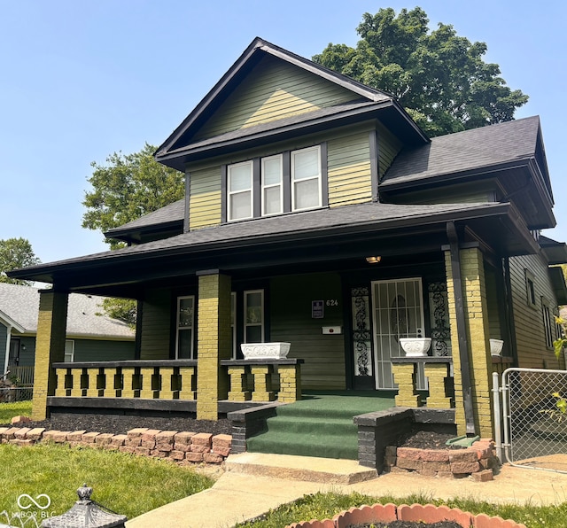 624 N Rural St, Indianapolis, IN 46201 - view of front of home with a porch, a shingled roof, and a gate