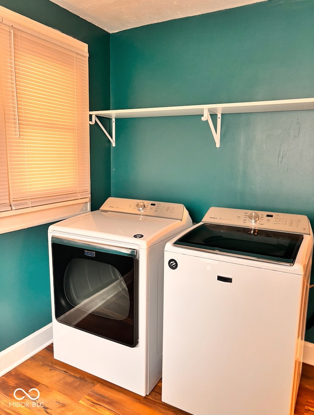 624 N Rural St, Indianapolis, IN 46201 - laundry room featuring washing machine and clothes dryer, wood finished floors, and baseboards