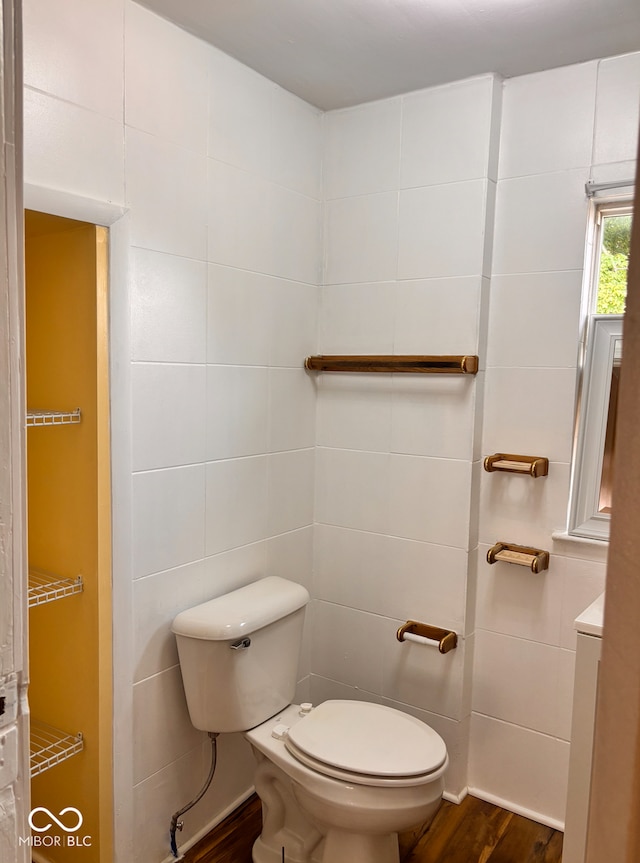 624 N Rural St, Indianapolis, IN 46201 - half bathroom with tile walls, wood finished floors, and toilet