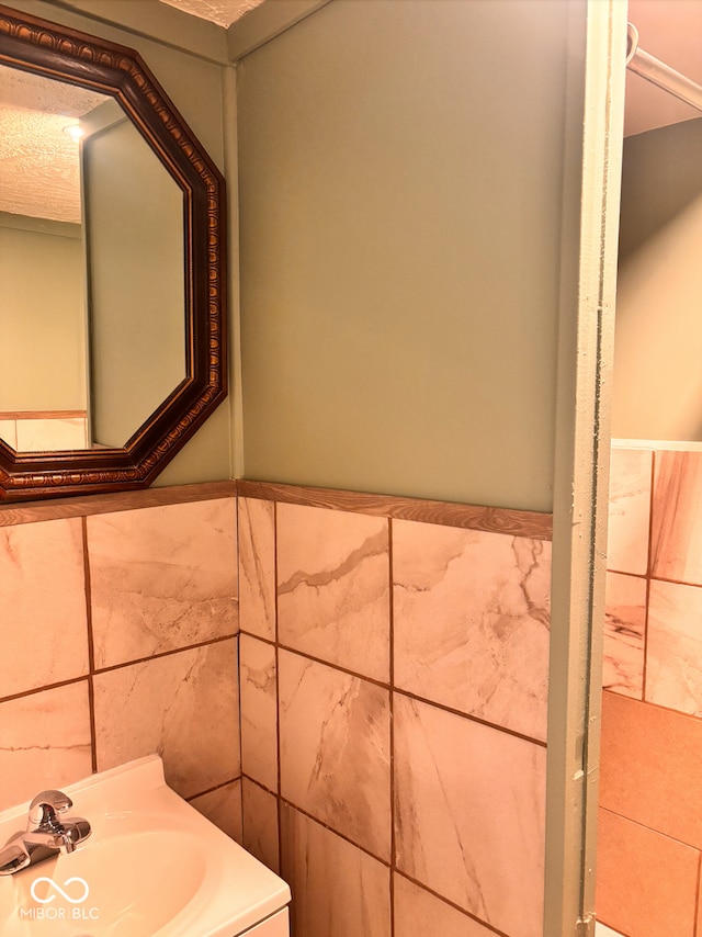624 N Rural St, Indianapolis, IN 46201 - bathroom with tile walls, vanity, and wainscoting