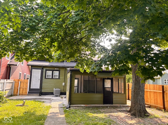 624 N Rural St, Indianapolis, IN 46201 - back of house with a fenced backyard, cooling unit, and a sunroom
