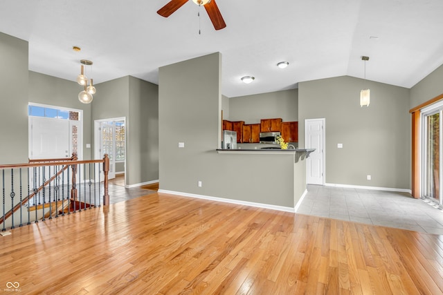 2948 Chalbury Dr, Plainfield, IN 46168 - unfurnished living room featuring light wood-type flooring, a ceiling fan, and vaulted ceiling
