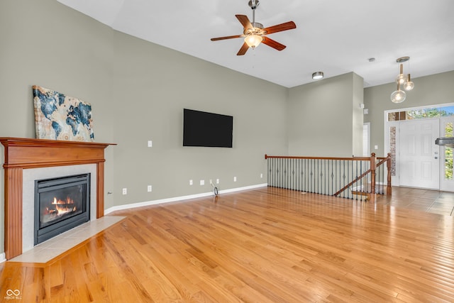 2948 Chalbury Dr, Plainfield, IN 46168 - unfurnished living room with a fireplace with flush hearth, wood finished floors, and ceiling fan