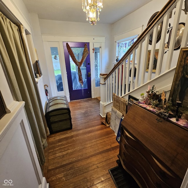 1617 Blaine Ave, Terre Haute, IN 47804 - foyer entrance with dark wood-style flooring, a chandelier, and stairs