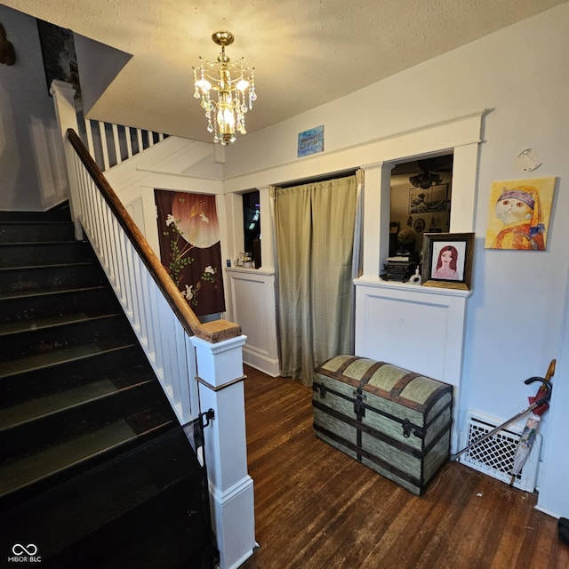 1617 Blaine Ave, Terre Haute, IN 47804 - stairs with wood finished floors, a chandelier, and a textured ceiling