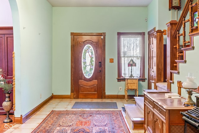 239 E 11th St, Indianapolis, IN 46202 - entrance foyer featuring stairway, arched walkways, and baseboards