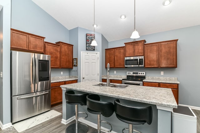 5439 Maywood Dr, Whitestown, IN 46075 - kitchen featuring appliances with stainless steel finishes, a sink, light countertops, an island with sink, and wood finished floors
