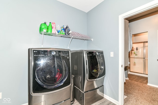 5439 Maywood Dr, Whitestown, IN 46075 - laundry area with washer and dryer, baseboards, carpet flooring, and wood finished floors