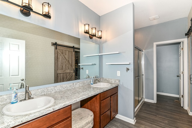 5439 Maywood Dr, Whitestown, IN 46075 - bathroom featuring wood finished floors, double vanity, baseboards, and a stall shower