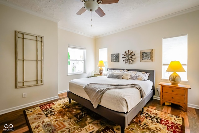 4305 W Coyote Run Ct, Muncie, IN 47304 - bedroom featuring ornamental molding, wood finished floors, baseboards, and ceiling fan