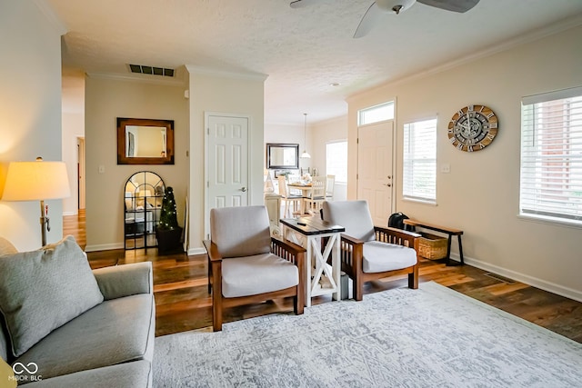 4305 W Coyote Run Ct, Muncie, IN 47304 - living room featuring crown molding, wood finished floors, ceiling fan, and baseboards