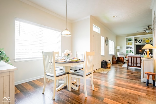 4305 W Coyote Run Ct, Muncie, IN 47304 - dining space featuring crown molding, ceiling fan, wood finished floors, and baseboards