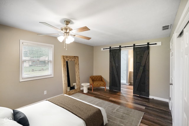 9378 N County Road 75 W, Lizton, IN 46149 - bedroom with a barn door, dark wood-style floors, baseboards, and a ceiling fan