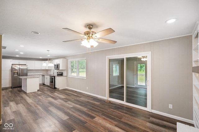 9378 N County Road 75 W, Lizton, IN 46149 - unfurnished living room with a sink, dark wood finished floors, a ceiling fan, baseboards, and crown molding