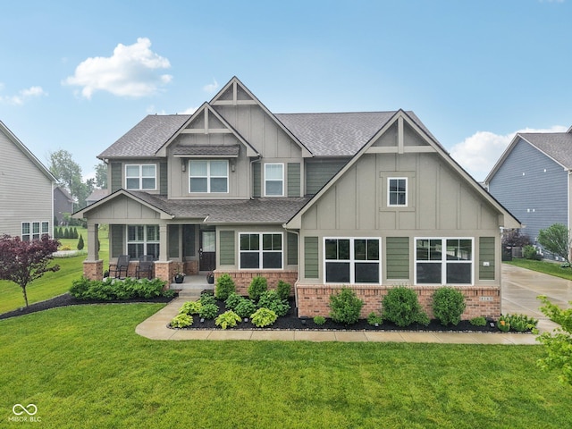 8165 Oakley Ter, Zionsville, IN 46077 - craftsman-style home featuring board and batten siding, brick siding, a front lawn, a shingled roof, and a porch