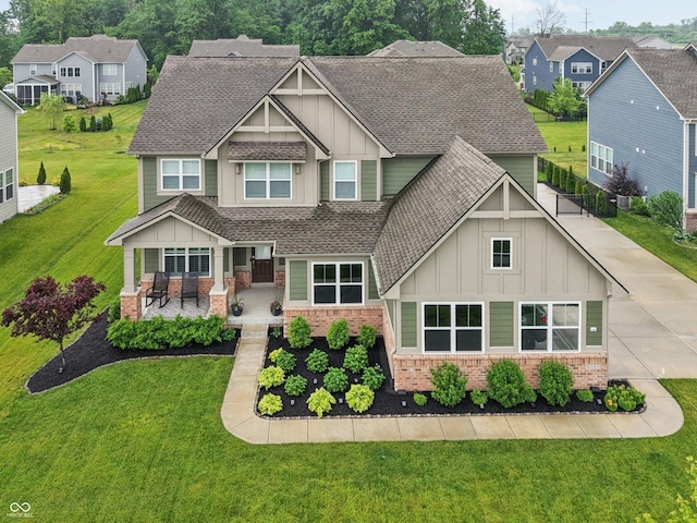 8165 Oakley Ter, Zionsville, IN 46077 - craftsman-style home with board and batten siding, brick siding, a shingled roof, and a front lawn