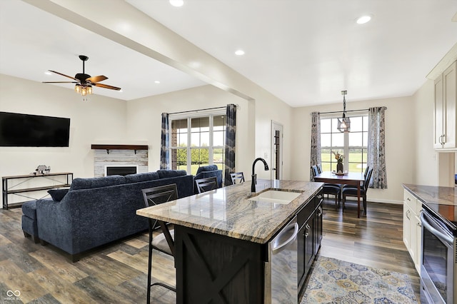 3301 N 200 W, Franklin, IN 46131 - kitchen featuring a sink, dark wood-type flooring, light stone countertops, a fireplace, and white cabinetry