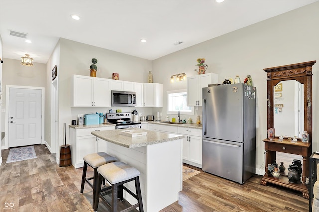 3301 N 200 W, Franklin, IN 46131 - kitchen with stainless steel appliances, a sink, white cabinetry, a kitchen island, and recessed lighting