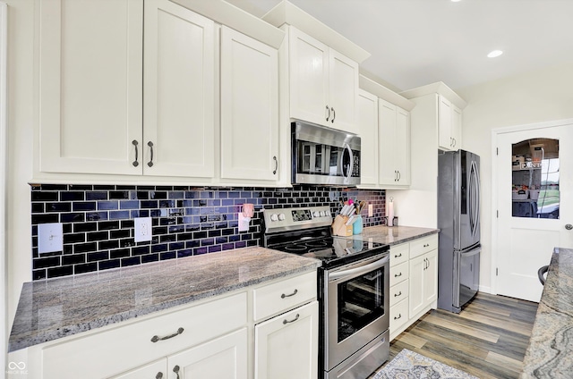 3301 N 200 W, Franklin, IN 46131 - kitchen featuring appliances with stainless steel finishes, white cabinetry, light wood-style flooring, and tasteful backsplash