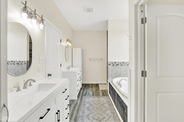 3301 N 200 W, Franklin, IN 46131 - full bath featuring two vanities, wood finished floors, a bath, and baseboards