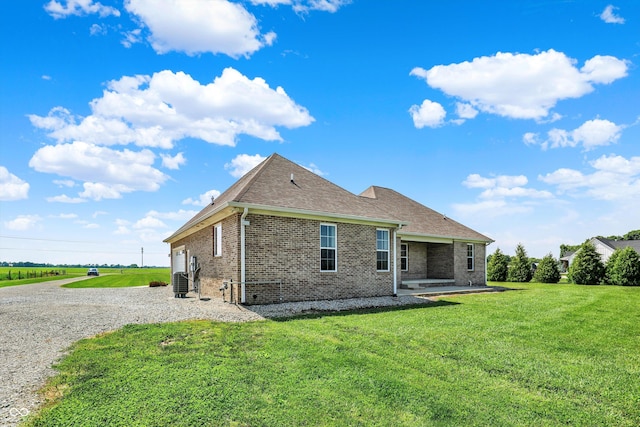 3301 N 200 W, Franklin, IN 46131 - back of property featuring brick siding, a yard, a shingled roof, central air condition unit, and driveway