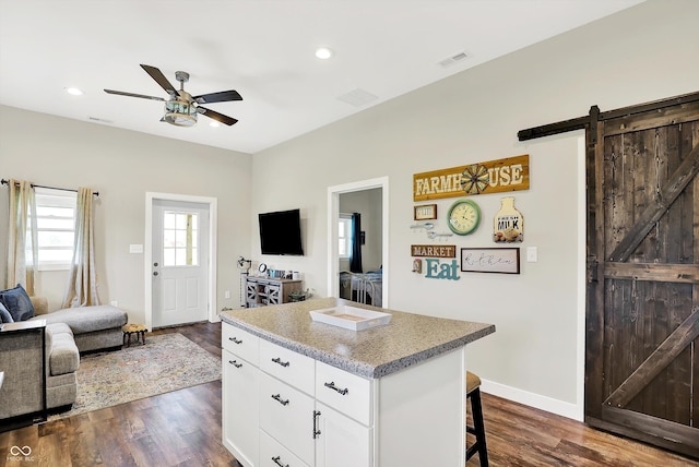 3301 N 200 W, Franklin, IN 46131 - kitchen featuring open floor plan, ceiling fan, a barn door, a center island, and dark wood finished floors